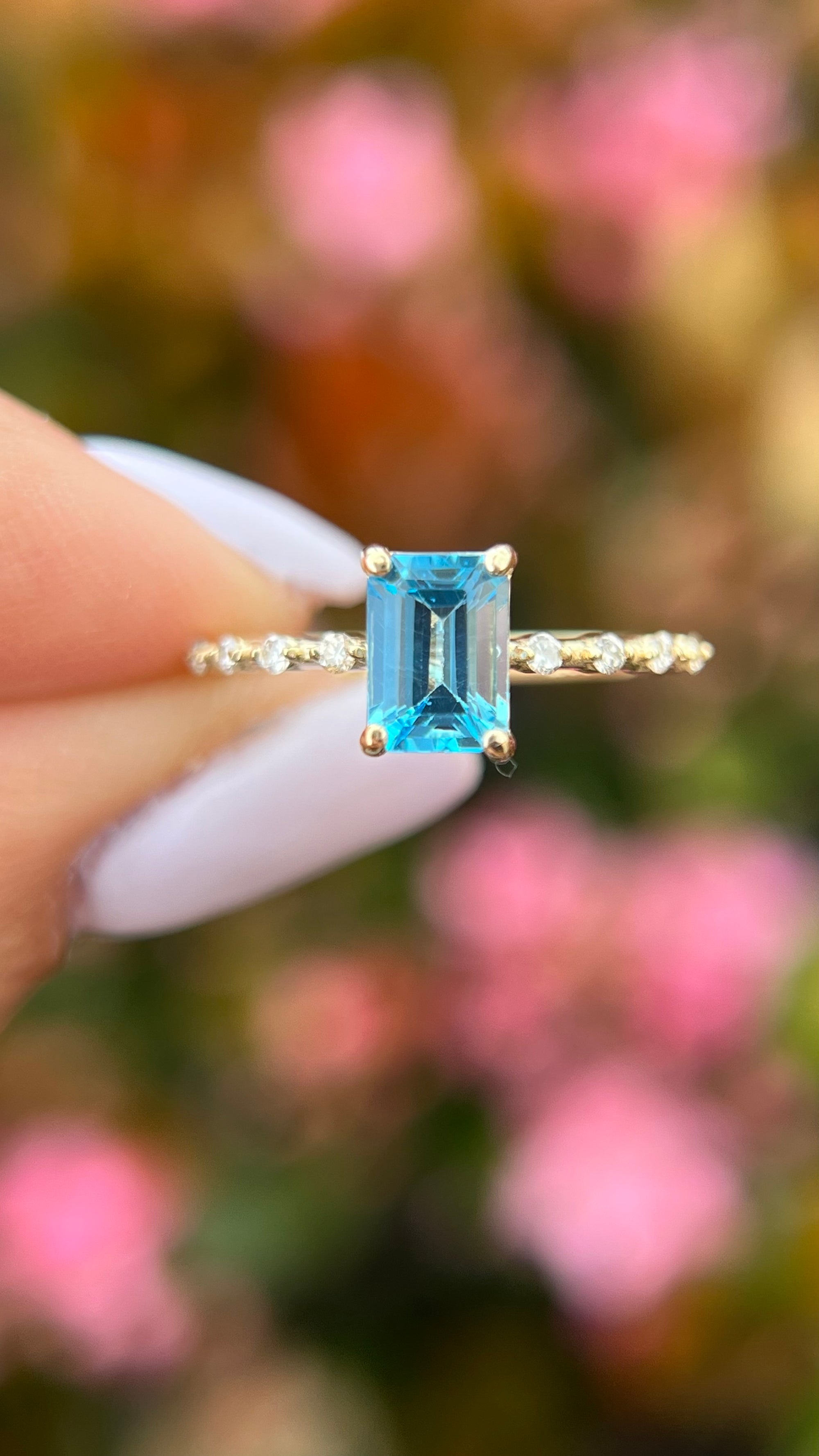 Bella 7x5mm 0.70ct Emerald Cut Blue Topaz Spaced Diamond Ring 14K Gold DFR035